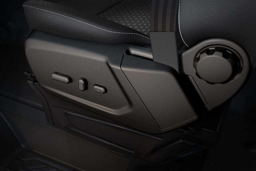 Controles eléctricos y manuales de ajuste de asiento en vehículo Ford.